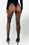 The Forever Fishnet tights—showcasing the elegant, lace-inspired geometric embroidery woven across fine fishnet mesh.