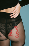 sheer black polka dot tights with red ‘Be Good’ embroidery—bold, intimate, and uniquely designed
