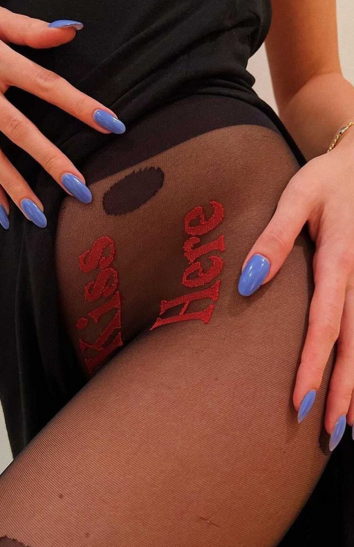 red ‘Kiss Here’ embroidery on sheer black tights—statement lingerie you can wear out
