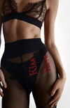 sheer black tights with red ‘Kiss Here’ embroidery—playful and hidden statement