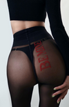 “Be Mine” red embroidery on sheer black tights—bold, flirty, and perfectly hidden for a cheeky reveal.
