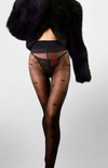 Close-up of delicate star embroidery on sheer tights by Betty